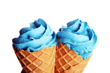 Vanilla frozen yogurt or colorful soft ice cream in waffle cone.