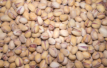 Roasted and salted pistachios in shell. Food background.