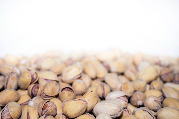 Roasted and salted pistachios in shell. Partial focus. Food background.