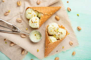 Pistachio ice cream with pistachio nuts and ice cream spoon, Top view, Flat lay.Summer mood