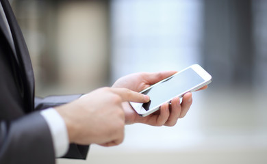 close up.the businessman clicks on the smartphone screen