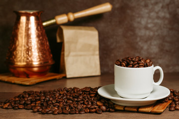 Turkish coffee brewing pot. Cup with coffee beans