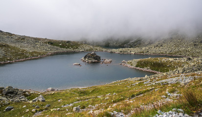 On the Shore of Foggy Zabie Mountain Lake in High Tatras Mountains, Slovakia
