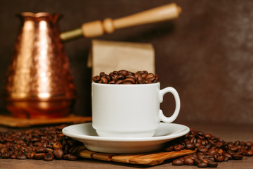 Turkish coffee brewing pot. Cup with coffee beans