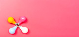 Colored light bulbs on a pink paper background