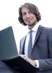 portrait of successful businessman working on laptop