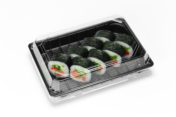 Traditional Sushi roll with salmon, nori and vegetables in a plastic container for take away