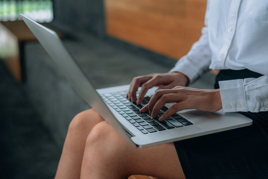 Woman Hands Typing Laptop Keyboard On Her Lap At The Office- Woman Office Worker And Businesswomen Concept