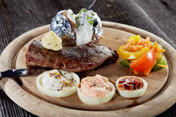 Rustic beef steak with oven potato and herb butter