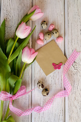 Easter egg and beautiful Tulips on a wooden background. - Image