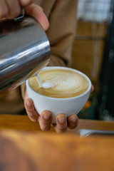 making of latte arte in white cup