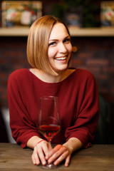Image of smiling woman with wine glass