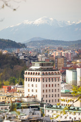 Neboticnik building and Ljubljana old town with mountains as a backdrop in Ljubljana, Slovenia