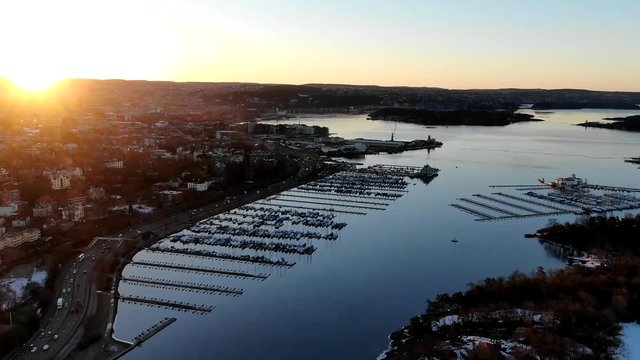 Aerial tima lapse towards Oslo city center and e18 highway over fjord in Norway at sunrise in spring 2019