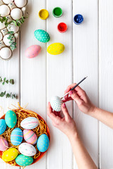 Traditional Easter eggs for paint on white wooden background top view