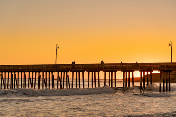 Fototapeta premium Orange sunset at the Beach and Pier 