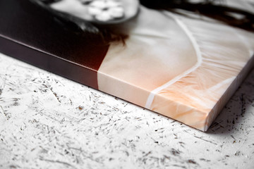 Gallery wrap, photo printed on glossy synthetic canvas and stretched on wooden stretcher bar, lateral side closeup. Selective focus