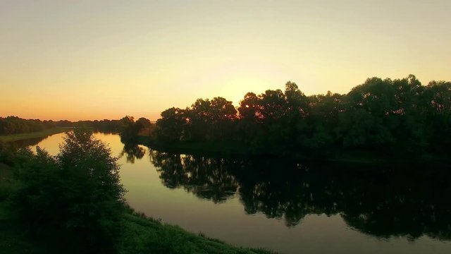 aerial view of river at sunrise 4K, fly over morning mist on the river, Very high view of the river at sunrise, Aerial view of mystical river at sunrise with fog, sun above the river aerial