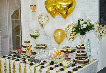 candy bar decorated by delicious sweet buffet with cupcakes and other desserts/candies,happy birthday concept
