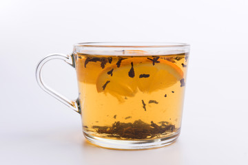 Glass cup of hot aromatic tea on white background