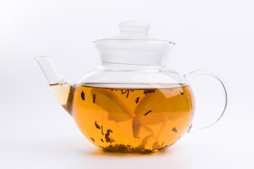 Glass teapot with black tea isolated on white background