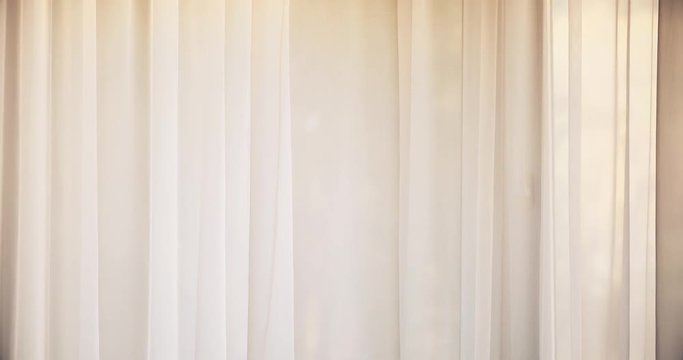 Window curtains swaying in the gentle wind, sunset light coming through.