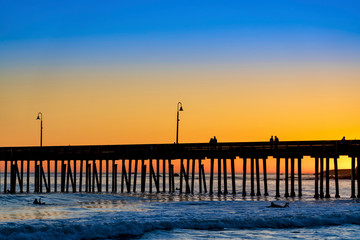 Silhouetted Pier at Sunset at Beach 