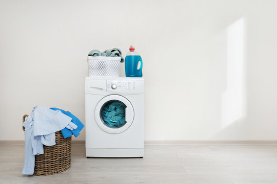 Laundry Room Interior With Washing Machine Near Wall