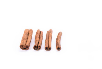 Four cinnamon sticks isolated on white background. Spice concept.