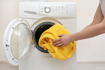 Laundry room interior with washing machine near wall