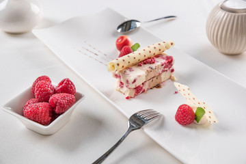 White chocolate and raspberries terrine - homemade ice cream with white chocolate, fresh raspberries, crispy biscuit and Belgian milk chocolate cubes.