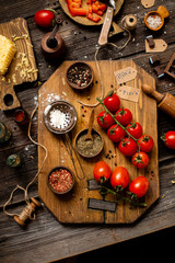 Overhead shot of branch ripe cherry tomatoes on wooden board 