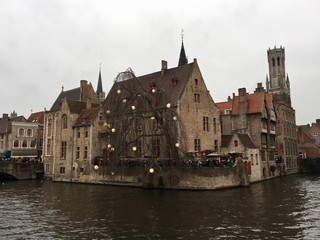 Naklejka premium The Rozenhoedkaai (Quay of the Rosary) with the Belfry of Bruges in the background is the most photographed area of ​​Bruges, West Flanders, Belgium.