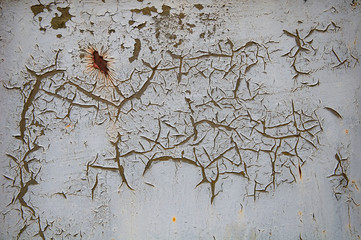 Background texture of old rusty damaged metal. Remains of multi-colored paint on an iron sheet.