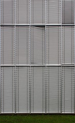 Contemporary facade detail with closed and broken window blinds