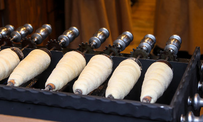 Baking of Trdelnik (a traditional Czech pastry)