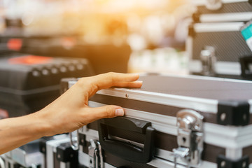 Female hand takes a small aluminum case
