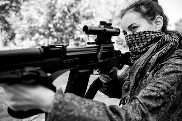Girl soldier with a sniper rifle in his hands. Military concept of women's army black and white photo
