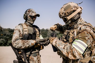 Soldiers reload rifles preparing to fire