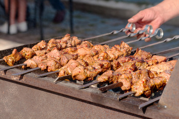 street food skewers, meat is fried on the fire, the process of cooking meat on the fire