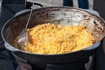 rice with meat, national Uzbek cuisine, national dish of pilaf, street food during the festival