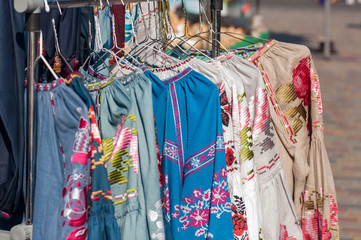 Fototapeta na wymiar national Ukrainian clothes are sold at the fair, hanging on a hanger