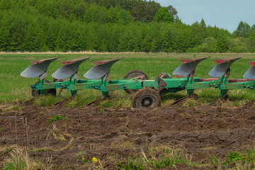 Agricultural tractor plows the land