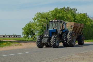 Agricultural tractor plows the land