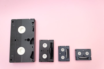 Old mini dv video tapes, retro concept. Video cassette on a pink background, Copy space