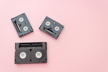 Old VHS videotapes, retro concept. Video cassette on a pink background