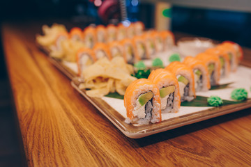 Sushi Smoked Philly plateau buffet in night dining resturant flat lay. Delicious Philadelphia salmon flesh seaweed and ginger. Rolls served on  plate in a restaurant. The norwegian salmon and Fish.