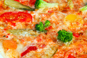 Obraz na płótnie Canvas Delicious pizza with broccoli, tomatoes and vegetables, with cucumber and pepper