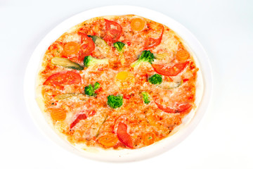 Delicious pizza with broccoli, tomatoes and vegetables on plate