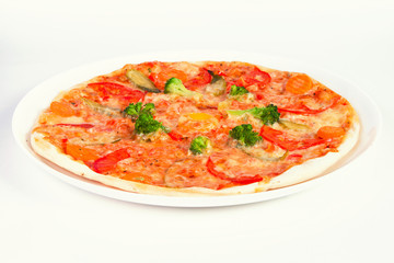 pizza with broccoli, tomatoes and vegetables on plate